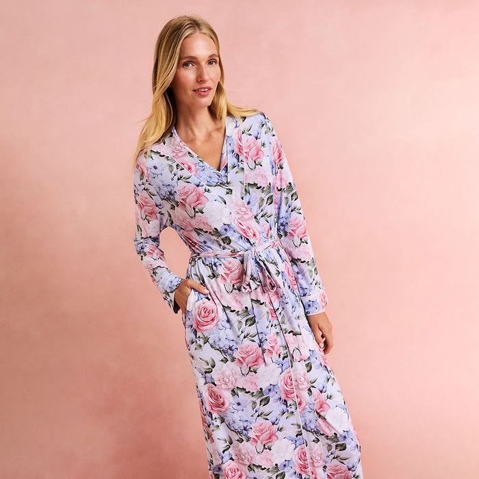 Woman wearing a floral robe against a pink background
