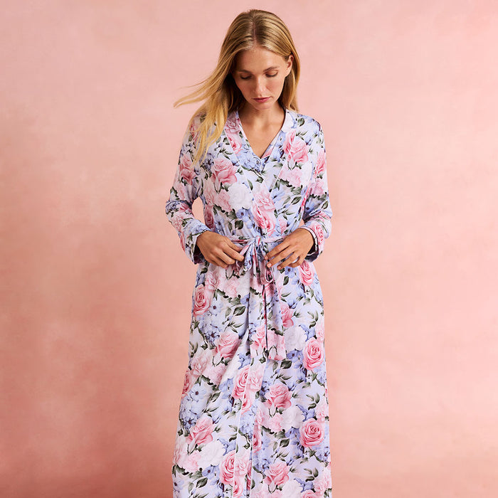 Woman wearing a floral robe against a pink background