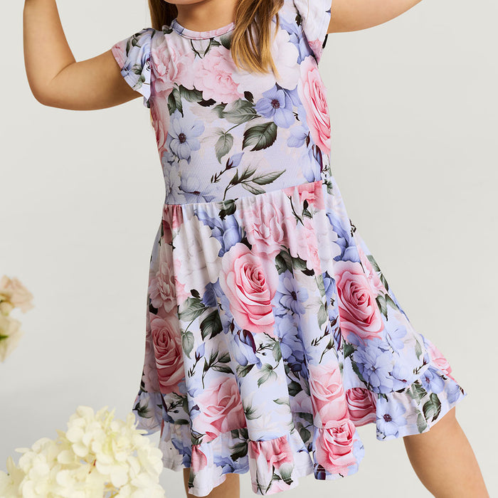 Floral dress with pink and purple flowers on a plain background
