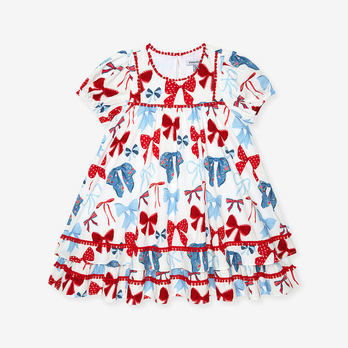 Dress with red and blue bow pattern on a white background