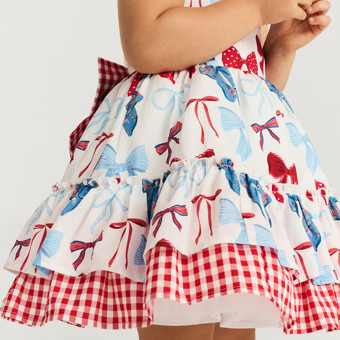 Dress with bow and checkered pattern on a plain background