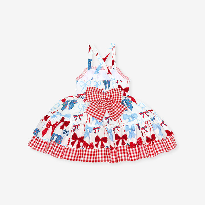 Children's dress with red and white checkered pattern and blue and red bow design on a white background