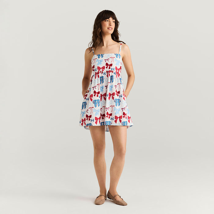 Woman wearing a patterned dress with a plain background
