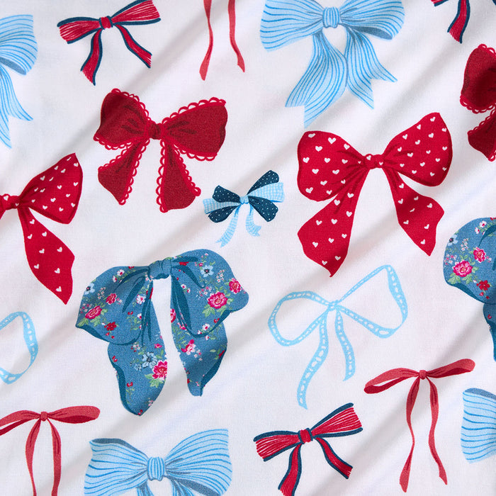 Pattern of red and blue bows on a white background