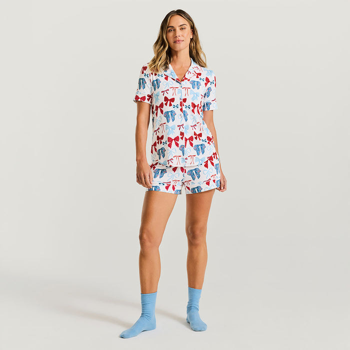 Woman wearing a patterned pajama set with a plain background