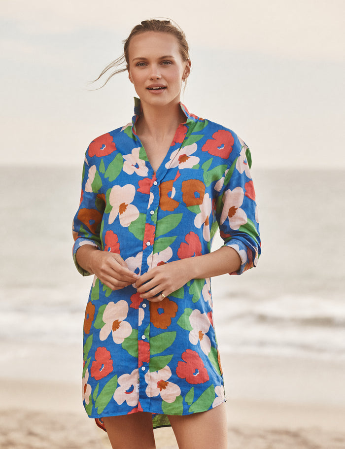 Woman wearing a colorful floral dress on a beach