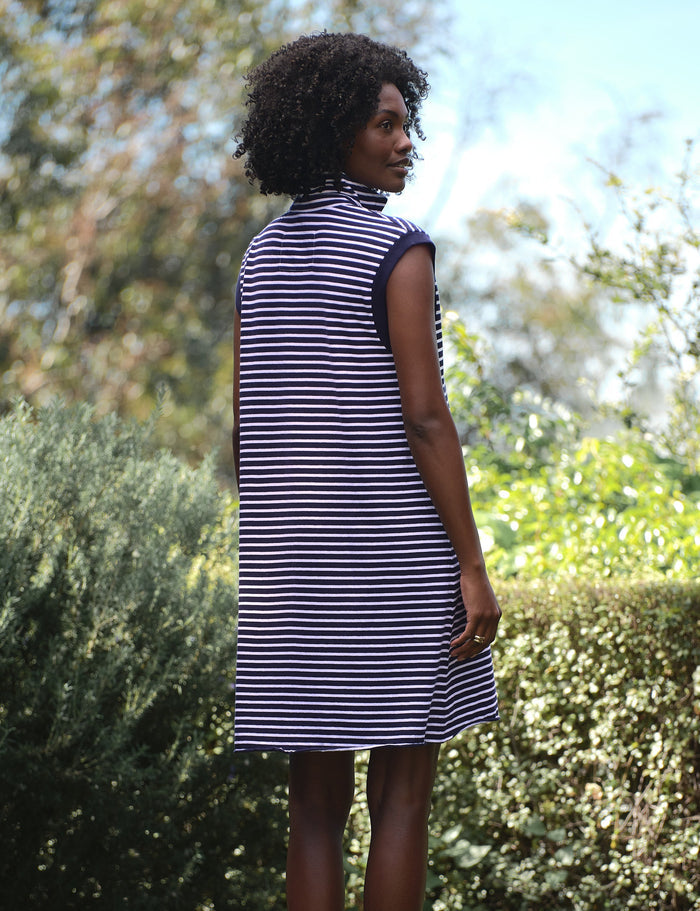 Woman wearing a striped dress standing in a garden