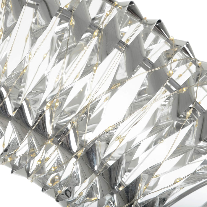 Close up of warm white LED lights on silver foil Christmas decoration