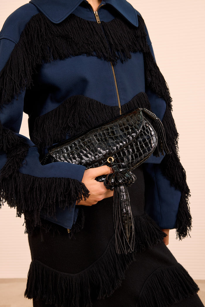 Paloma Tassel Flap Bag Noir Held as Clutch - Styled Look with Fringed Jacket | Ulla Johnson