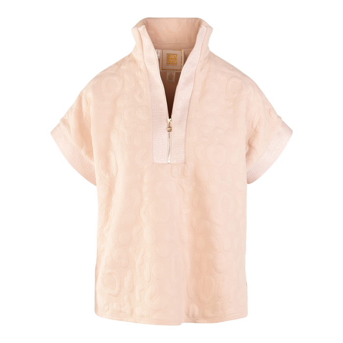 The Poppy Pullover is a light pink top with a textured, embossed cheetah pattern, short cuffed sleeves, a half-zip front, and a stand collar. Its soft, cozy fabric makes it pop against the black background.