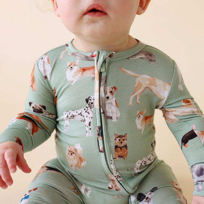 close-up of child wearing a dog patterned print one piece