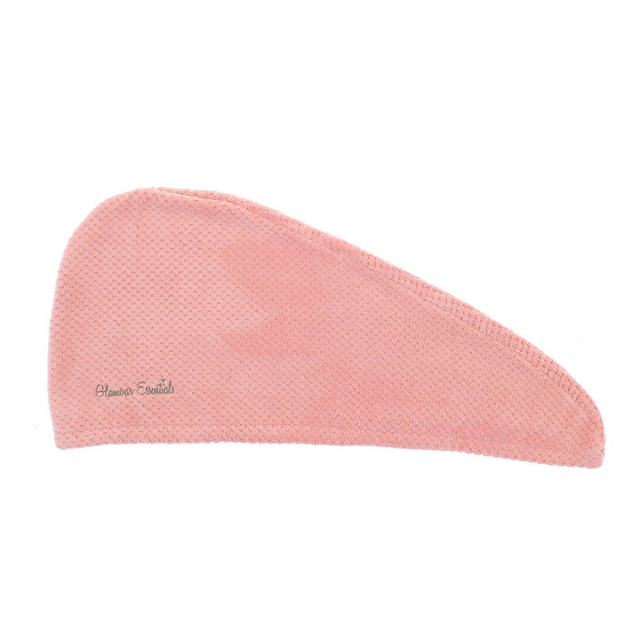 Pink hair drying turban with waffle texture laid flat on a white background