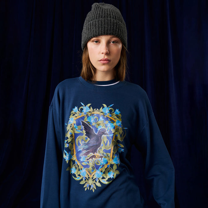 Person wearing Harry Potter Ravenclaw sweatshirt with crest graphic