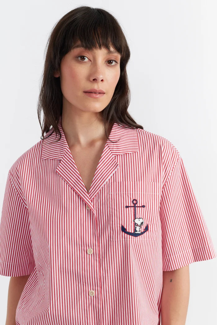Woman wearing a red and white striped shirt with an anchor design on a white background