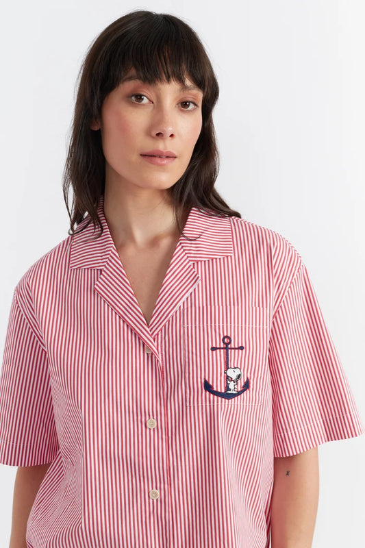 Woman wearing a red and white striped shirt with an anchor design on a white background
