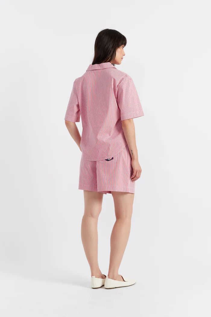 Person wearing a pink outfit on a white background