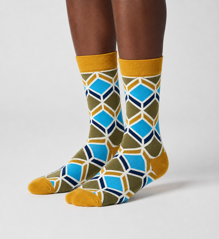 Sandstone Mosaic crew socks flat lay showing warm desert-tone geometric mosaic pattern