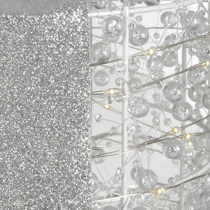 Close up of glitter ribbon and white LED lights on a Christmas decoration