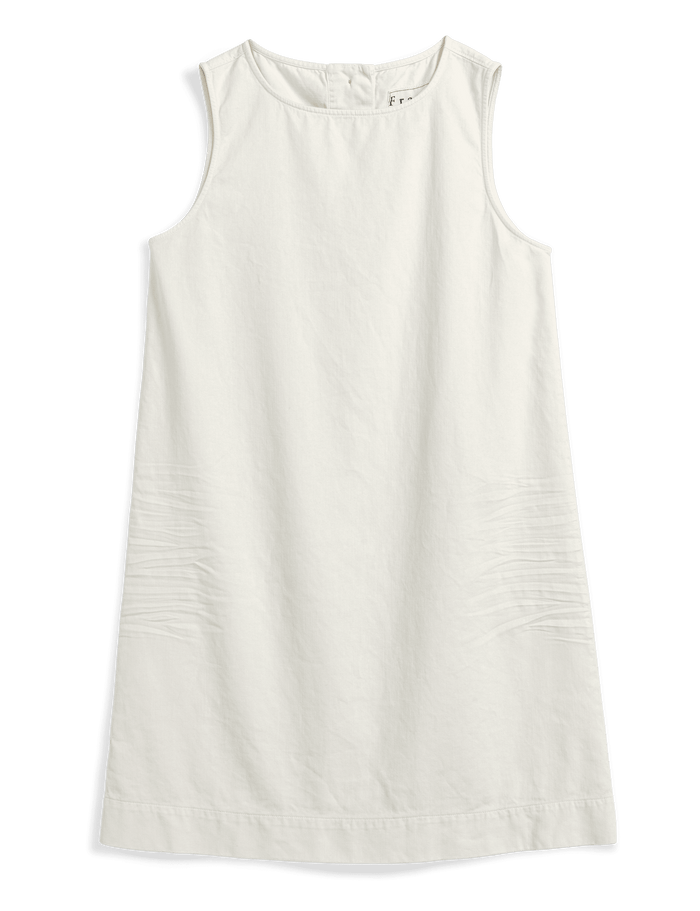 A sleeveless white shift dress with a relaxed, slightly flared silhouette, laid flat against a solid dark green background.