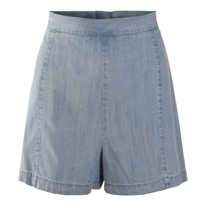 The Tailored Short features light blue denim chambray, a high waist, loose fit, subtle seam details, and a simple, classic design.