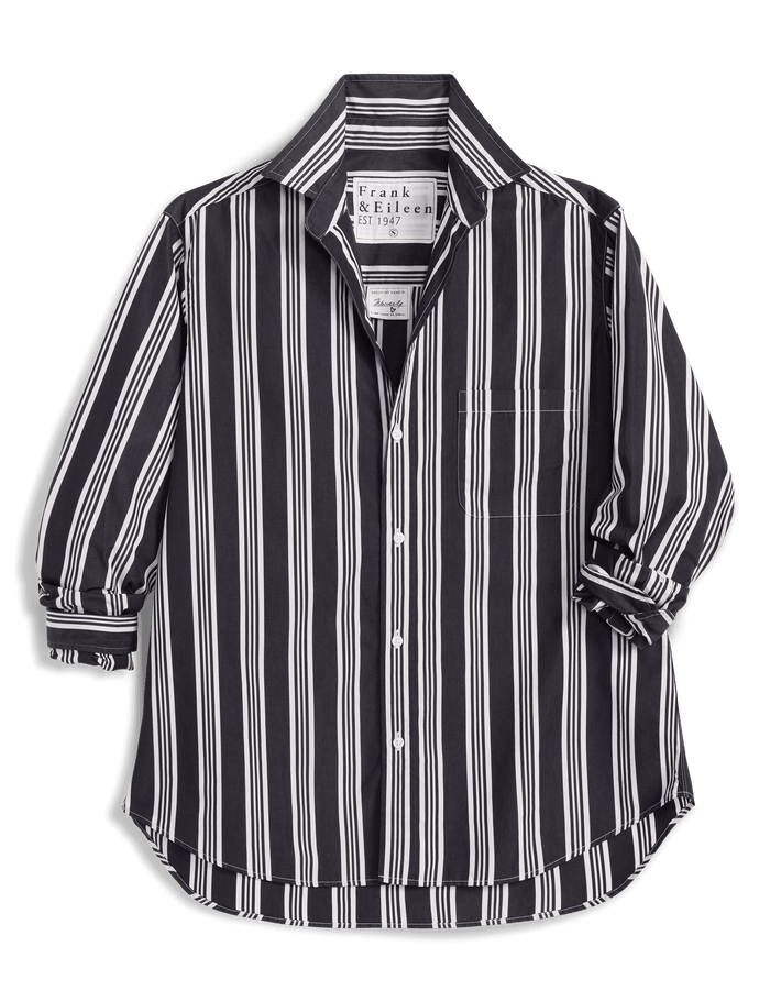 A Frank & Eileen long-sleeve button-up shirt with vertical black and white stripes, displayed against a solid green background.