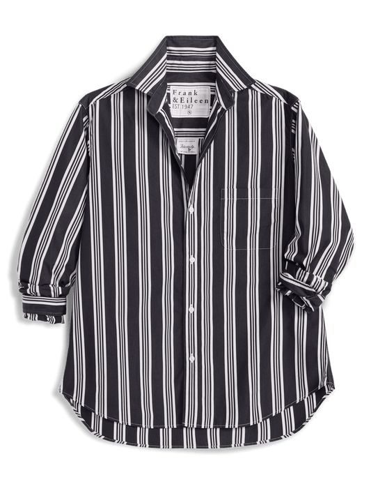 A Frank & Eileen long-sleeve button-up shirt with vertical black and white stripes, displayed against a solid green background.