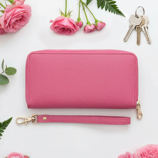 Pink purse with a wrist strap, keys, and pink roses on a white background